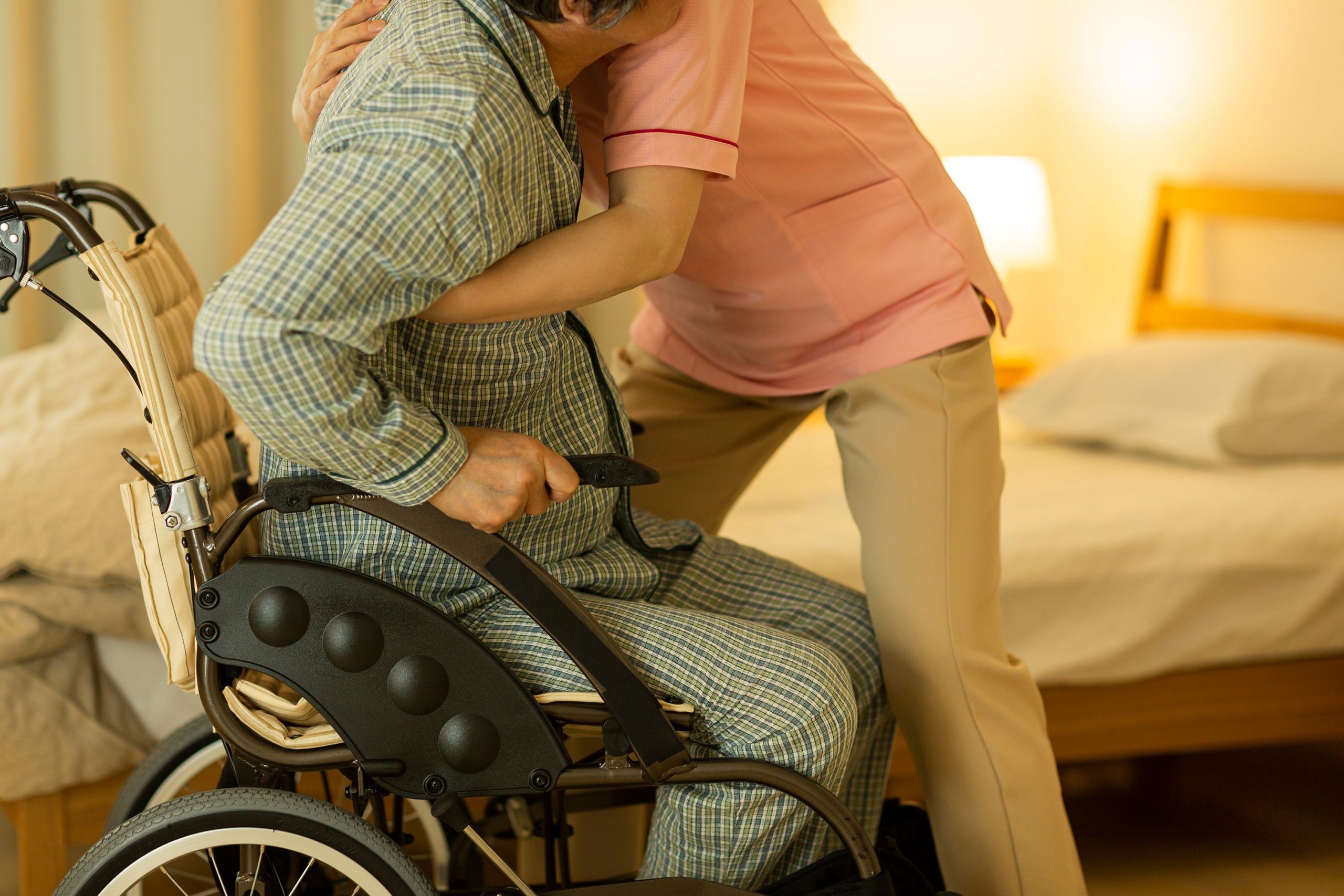 Senior man being cared by a female caregiver