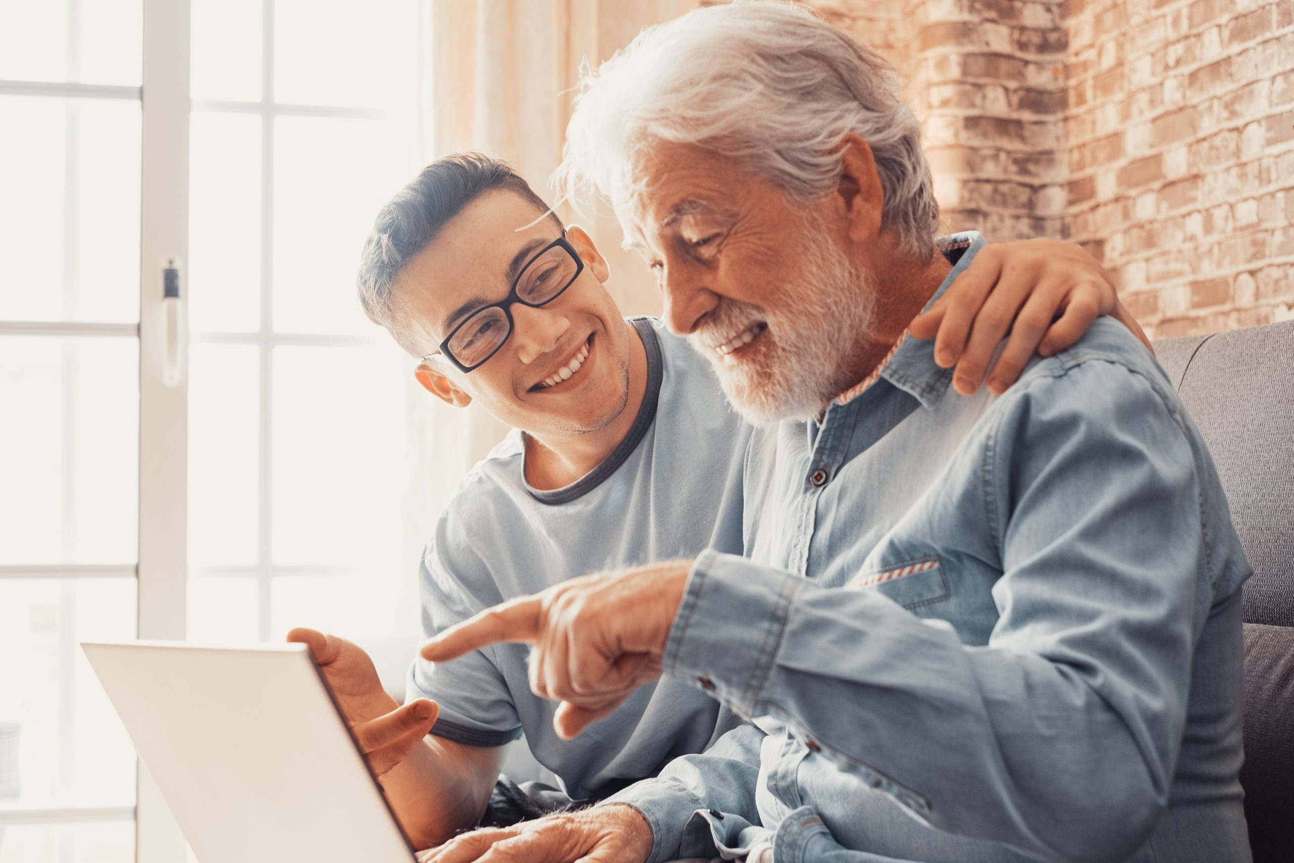 Smiling boy helping older man